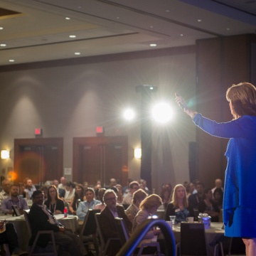 A picture of APQC staff member Cindy Hubert keynoting at APQC's Annual KM Conference