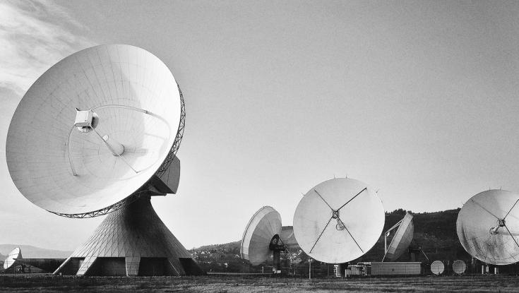 satellite dishes in a field - indicating broadcasting industry
