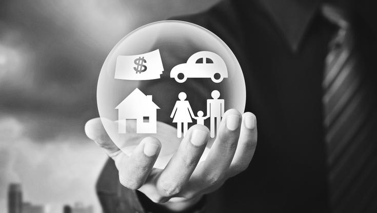 hand holding ball with icons that represent money, a car, a family, and a house