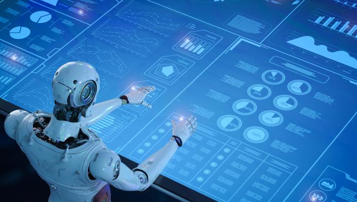 A picture of a robot working a computer screen