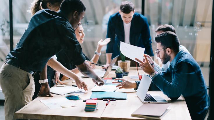 Picture of folks working around a table
