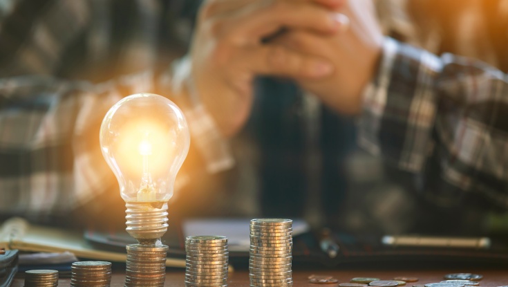 Light bulb with coins stack