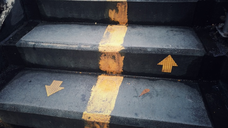staircase with up and down arrow signs on the ground