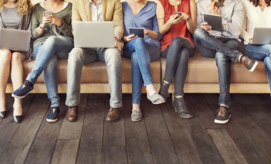 Photo of next generation workers with laptops and tablets