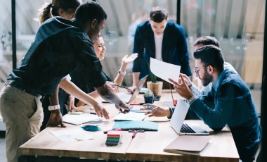 Picture of folks working around a table