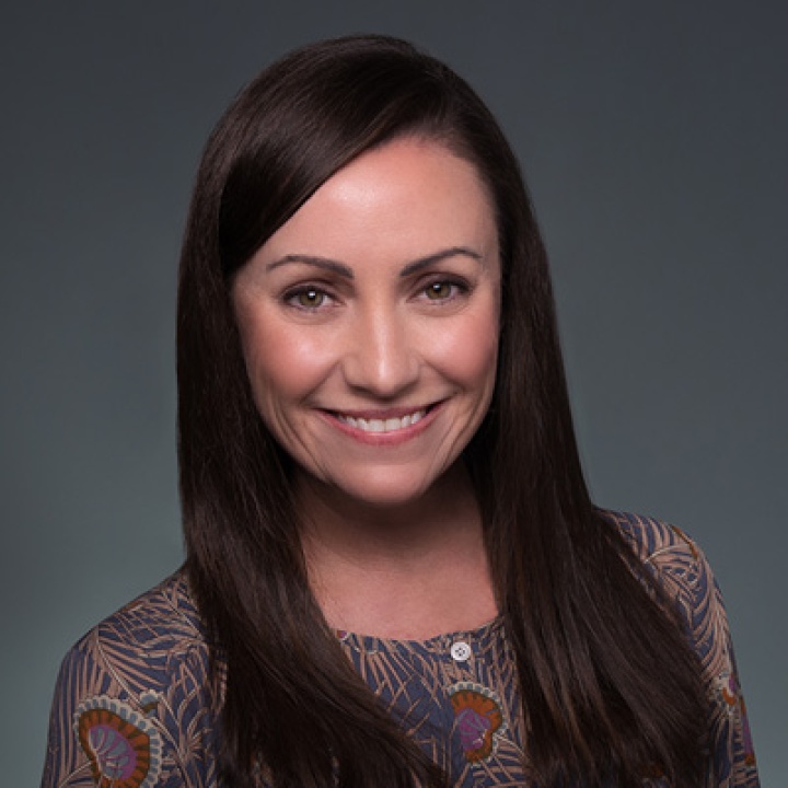 A picture of Amanda Schalyo in front of a gray background