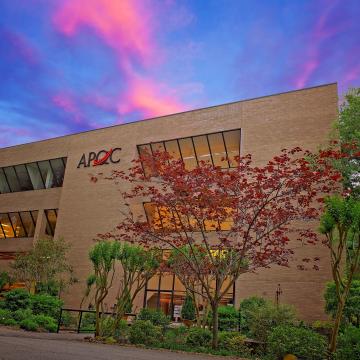 A picture of the APQC building at sunset 