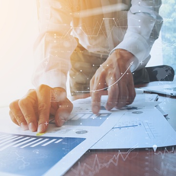 image of person looking at data on table