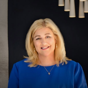 A picture of our CEO Lisa Higgins standing in our lobby