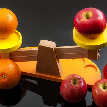 graphic, apples and oranges on a scale