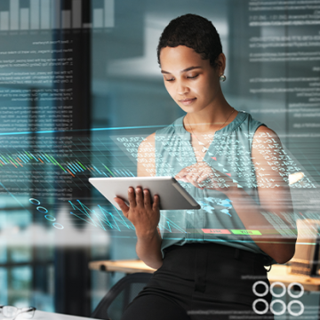A woman holding a tablet, looking at data