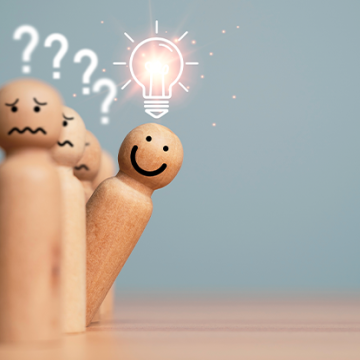 Image of a smiling wooden peg with a lightbulb