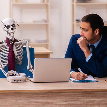 Skeleton sitting at a desk, Reconciling your ledger takes too long  