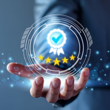 Image of a man's hand holding a digital round ball with an award checkmark and stars under it. 