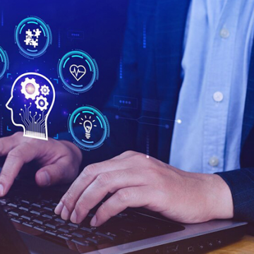 Man typing on computer with icons of a brain