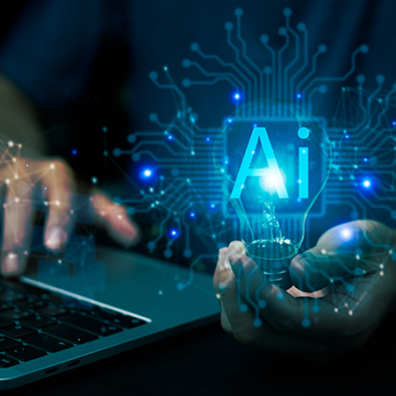 Man with computer holding AI symbol