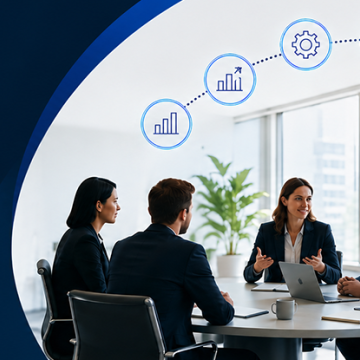 A team of professionals meets around a conference table while discussing business growth, operations, and workforce strategies.