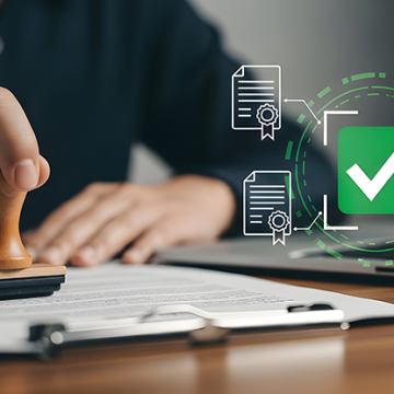 A person stamps a document while digital certification and approval icons appear beside a laptop.